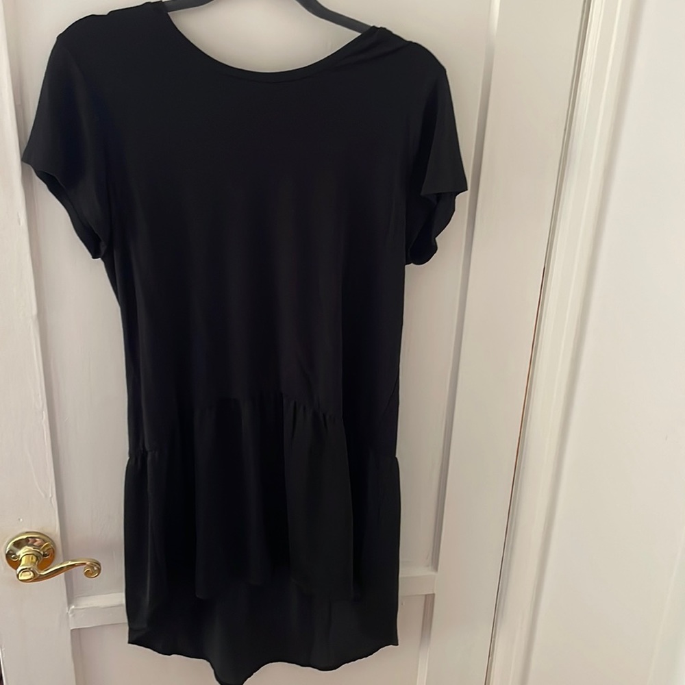 Anthropologie black shirt with sheer bottom.